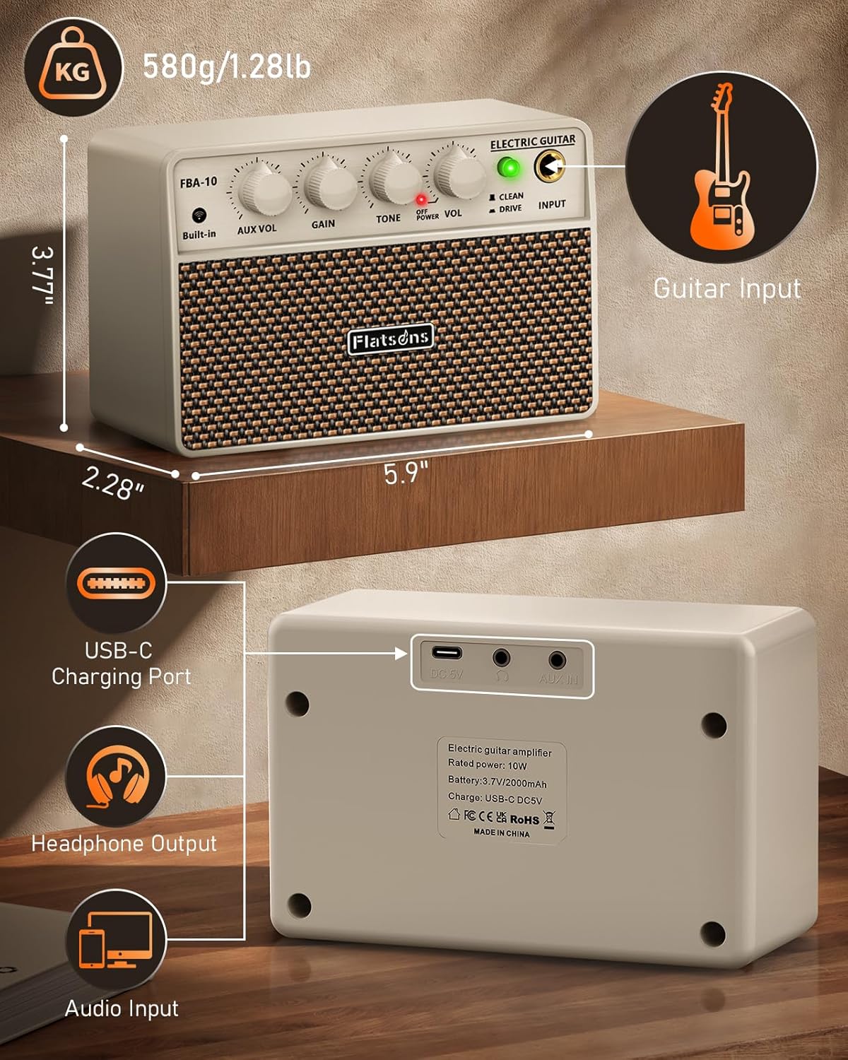 Flatsons FBA-10 white wireless portable amplifier on a wooden desk with coffee mug, smartphone, and electric guitar neck